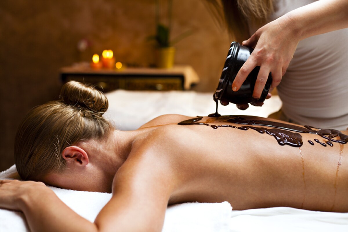 Woman having a massage with hot chocolate