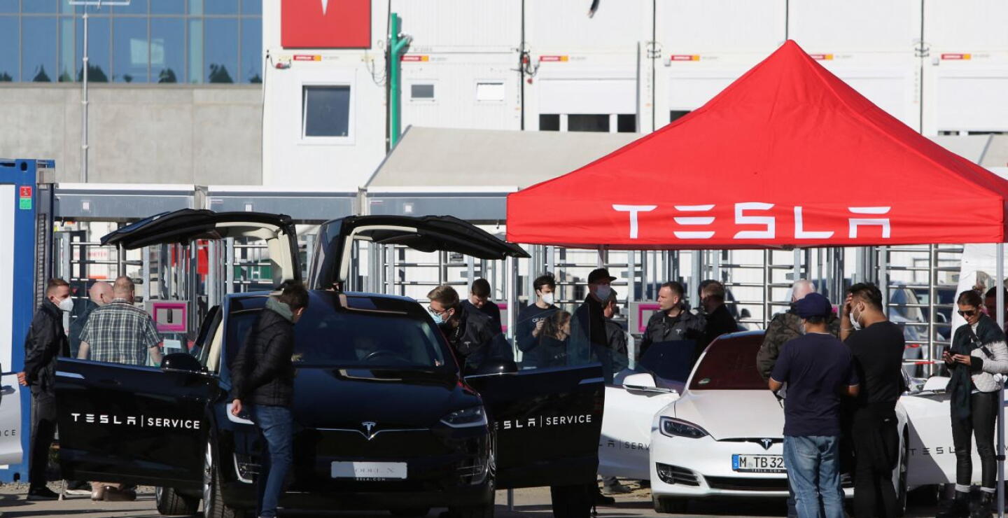 Visitors look at Tesla cars during the "Gigafest" open house county fair-style event, in which local residents were invited to visit the Tesla automobile company's Gigabit factory construction site in Gruenheide, near Berlin on October 9, 2021.