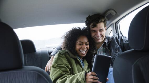 Young couple taking selfie in car during road trip Young couple taking selfie in car during road trip