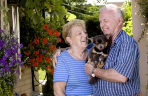 Smiling senior couple holding a puppy