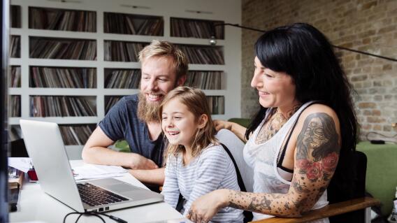 Young Family Browsing Internet With Laptop Young Family Browsing Internet With Laptop
