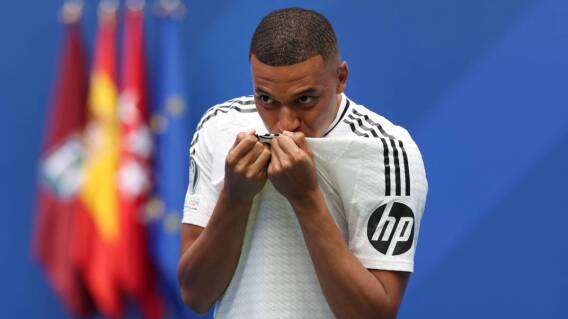 French forward Kylian Mbappe kisses his jersey during his first appearance as a Real Madrid player at the Santiago Bernabeu Stadium in Madrid on July 16, 2024, after signing his new five-season contract. French forward Kylian Mbappe kisses his jersey during his first appearance as a Real Madrid player at the Santiago Bernabeu Stadium in Madrid on July 16, 2024, after signing his new five-season contract.